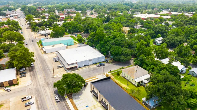 an aerial view of a house with a yard basket ball court and outdoor seating