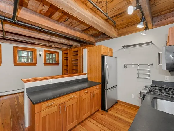 a kitchen with stainless steel appliances granite countertop a refrigerator and a stove top oven