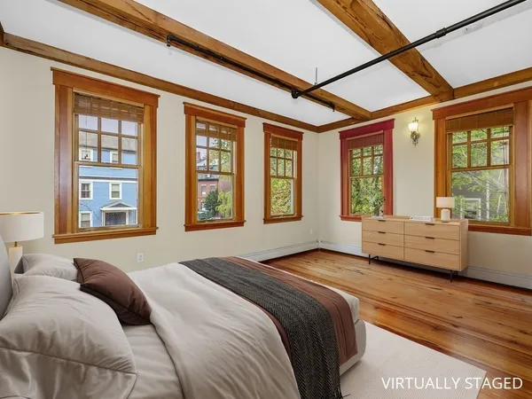 a bedroom with a large bed and a large window