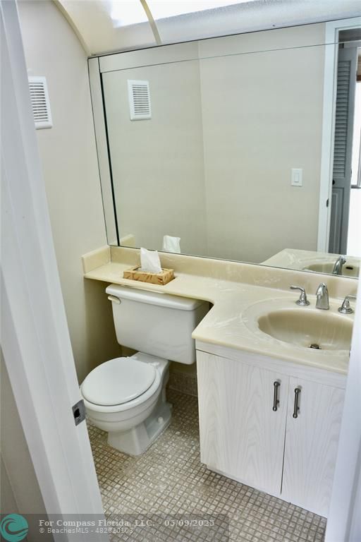 4070 Exeter Boca Raton, FL 33434 - Photo 11 of 59 a white toilet sitting next to a bathroom sink