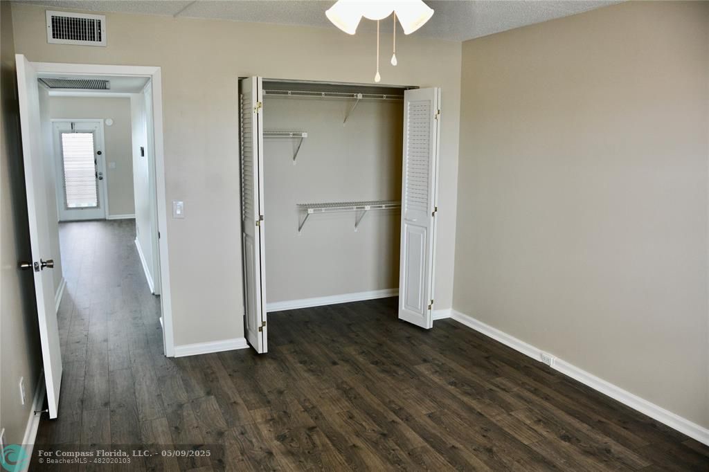4070 Exeter Boca Raton, FL 33434 - Photo 17 of 59 an empty room with wooden floor and a ceiling fan