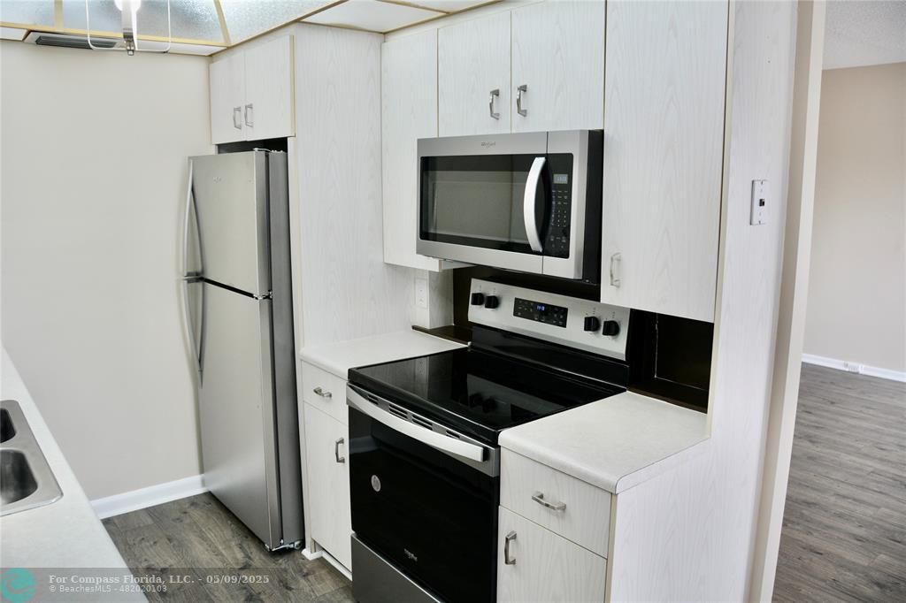 4070 Exeter Boca Raton, FL 33434 - Photo 2 of 59 a kitchen with stainless steel appliances white cabinets and a stove