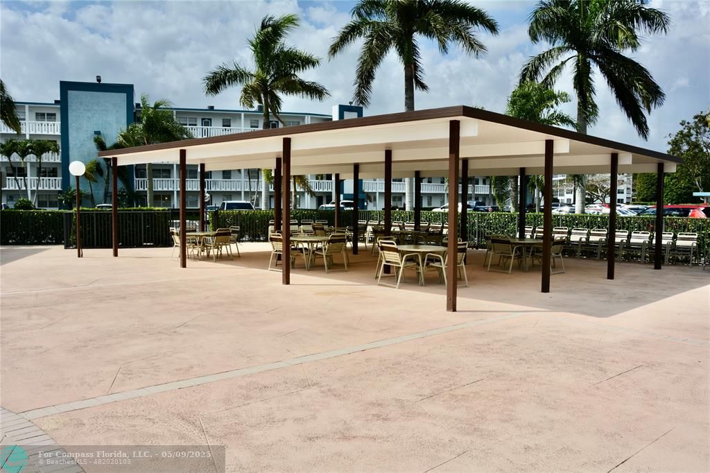 4070 Exeter Boca Raton, FL 33434 - Photo 24 of 59 a view of a patio with a table and chairs under an umbrella