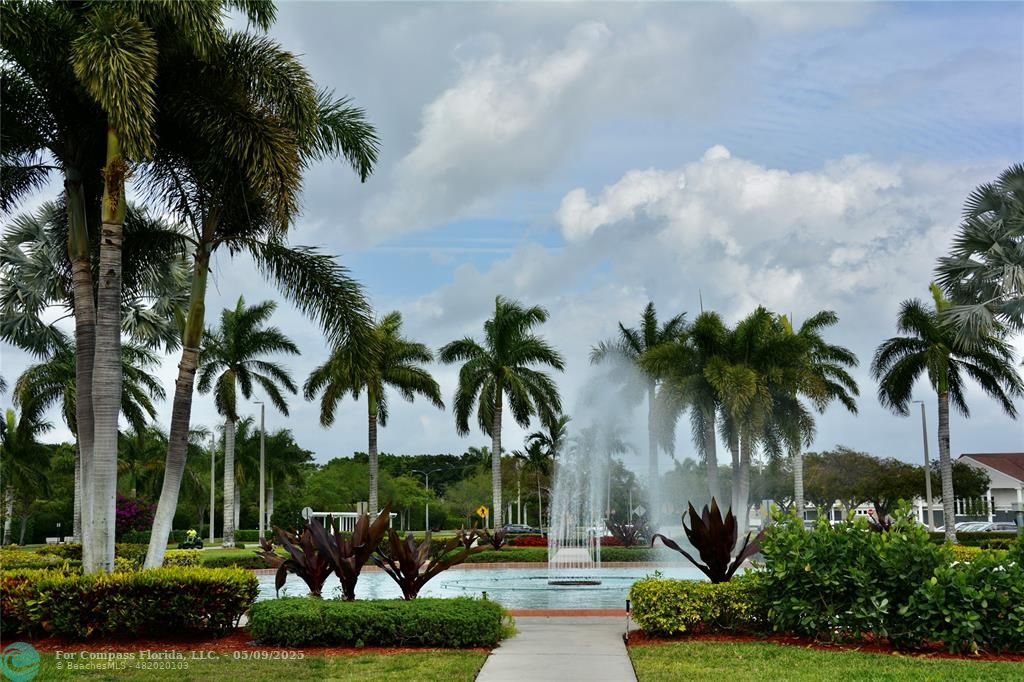 4070 Exeter Boca Raton, FL 33434 - Photo 29 of 59 a palm tree sitting in front of a house with a garden