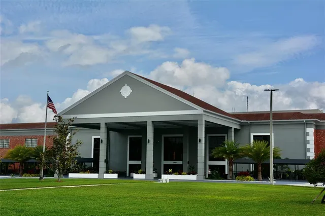 a view of a house with a swimming pool and sitting area