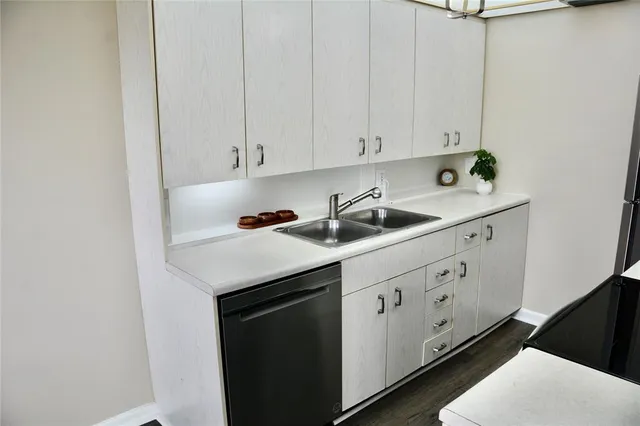a kitchen with granite countertop white cabinets and white appliances