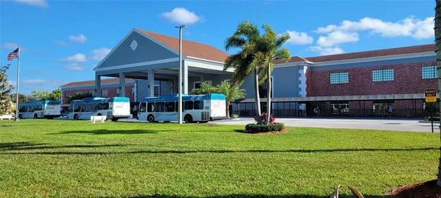 a kitchen with a sink a refrigerator and cabinets