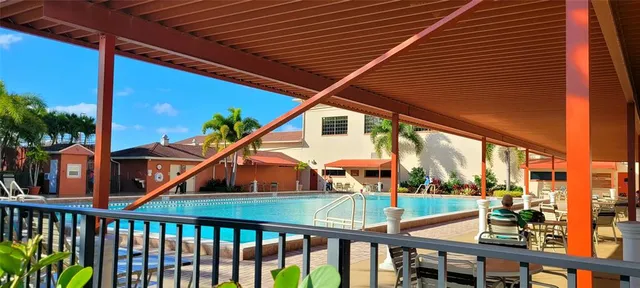 a kitchen with a refrigerator and a stove top oven