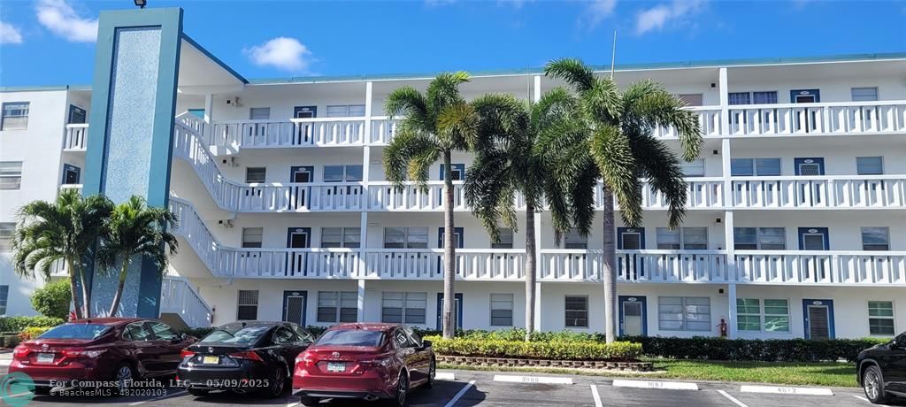 4070 Exeter Boca Raton, FL 33434 - Photo 39 of 59 a front view of a multi story building with yard