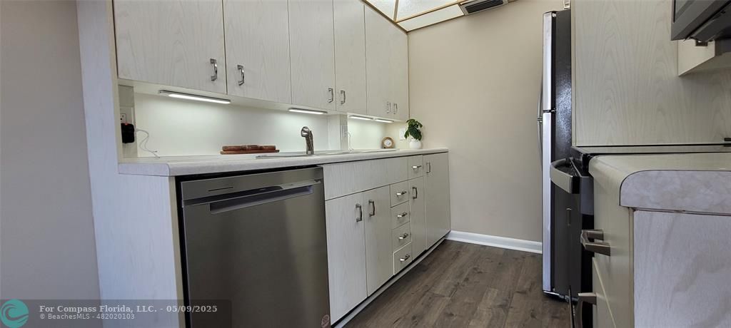 4070 Exeter Boca Raton, FL 33434 - Photo 40 of 59 a kitchen with a sink a refrigerator and cabinets