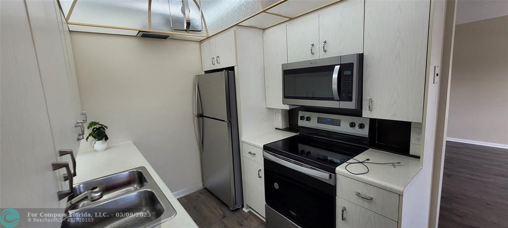 4070 Exeter Boca Raton, FL 33434 - Photo 41 of 59 a kitchen with a refrigerator and a stove top oven