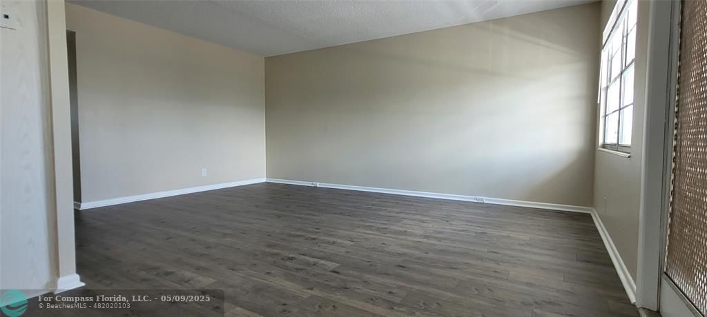 4070 Exeter Boca Raton, FL 33434 - Photo 43 of 59 a view of an empty room with wooden floor and a window