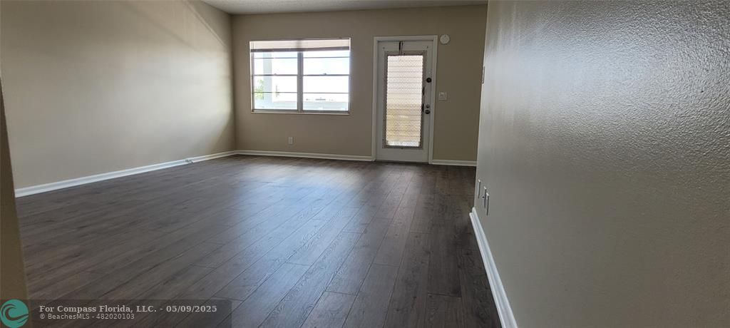 4070 Exeter Boca Raton, FL 33434 - Photo 44 of 59 an empty room with wooden floor and windows
