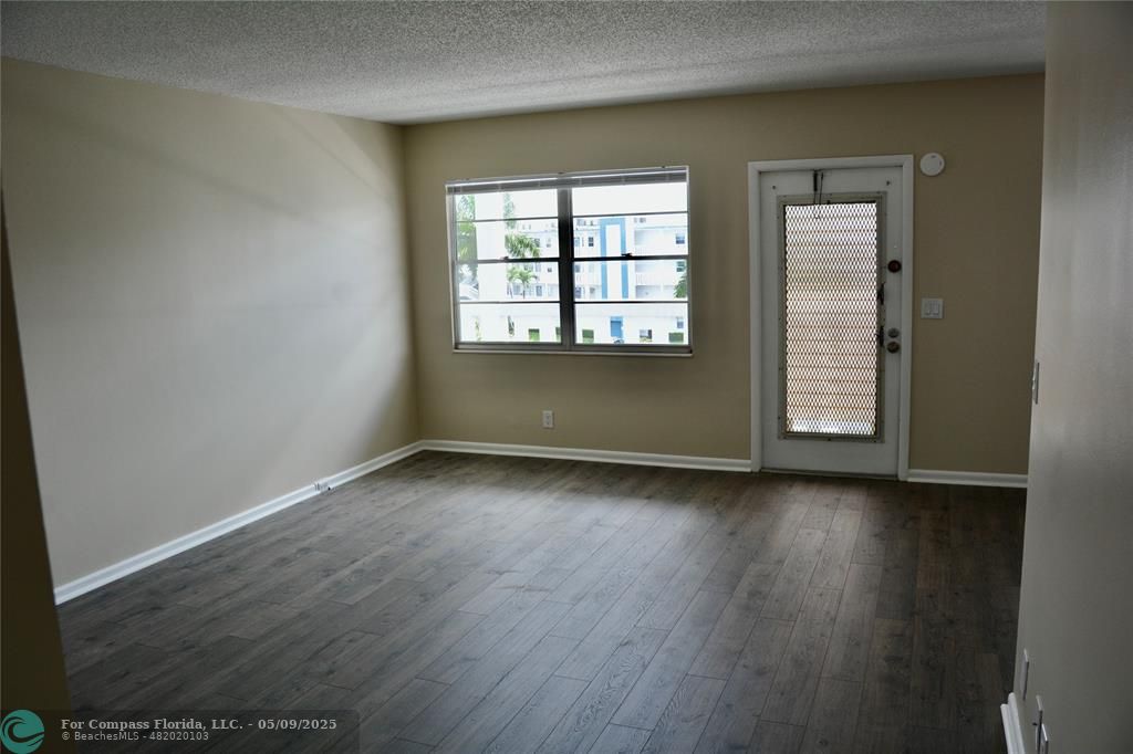 4070 Exeter Boca Raton, FL 33434 - Photo 6 of 59 an empty room with wooden floor and window