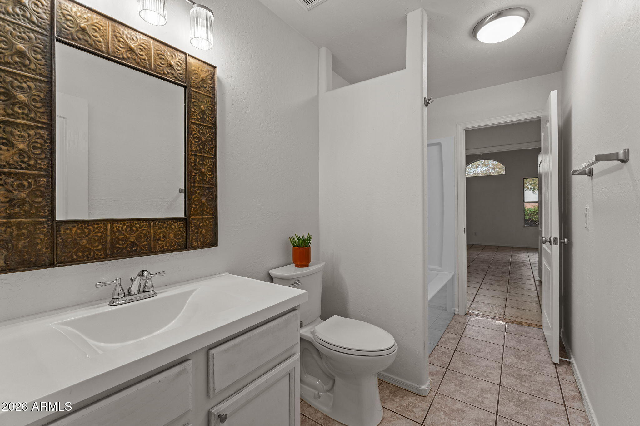 20220 North 9th Street Phoenix, AZ 85024 - Photo 28 of 36 a bathroom with a toilet a sink a mirror and vanity