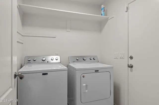 a view of a backyard with plants and outdoor kitchen