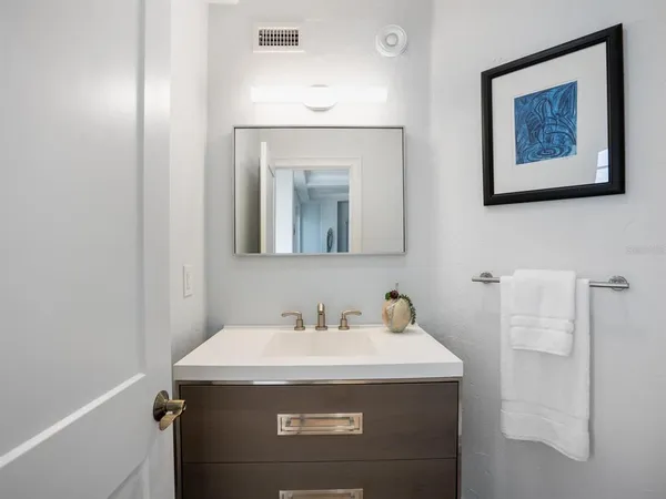 a bathroom with a granite countertop sink a toilet and shower