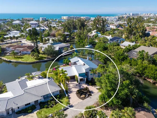 an aerial view of a house with swimming pool outdoor seating and mountain view