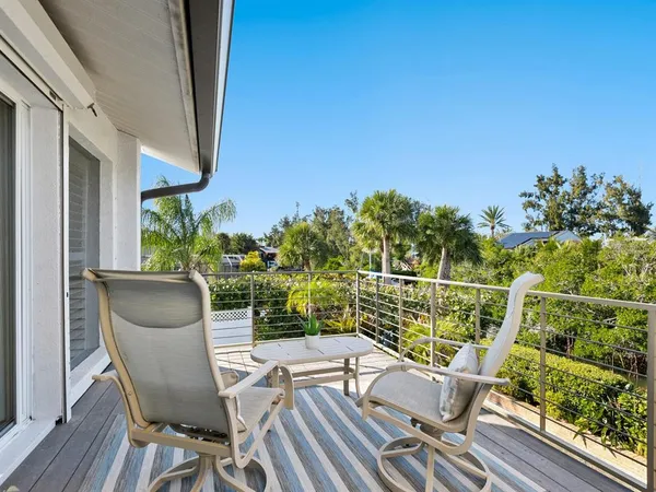 a view of a patio with table and chairs and potted plants