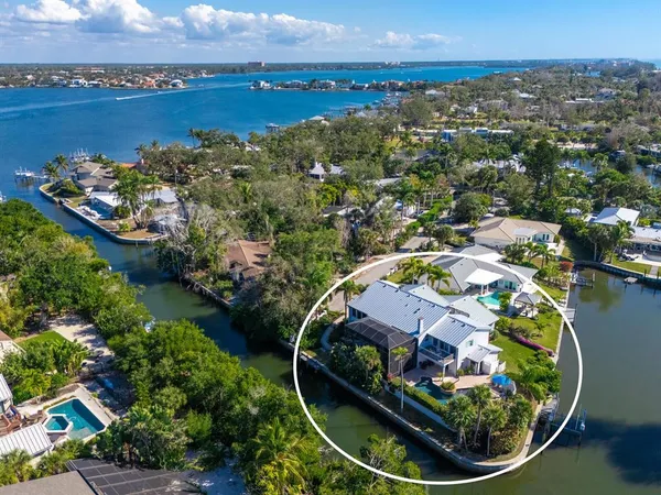 an aerial view of a house with a garden and lake view