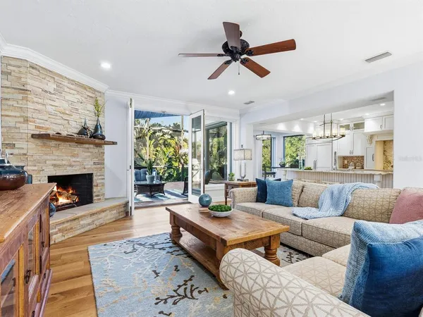 a kitchen with stainless steel appliances a dining table chairs and wooden floor
