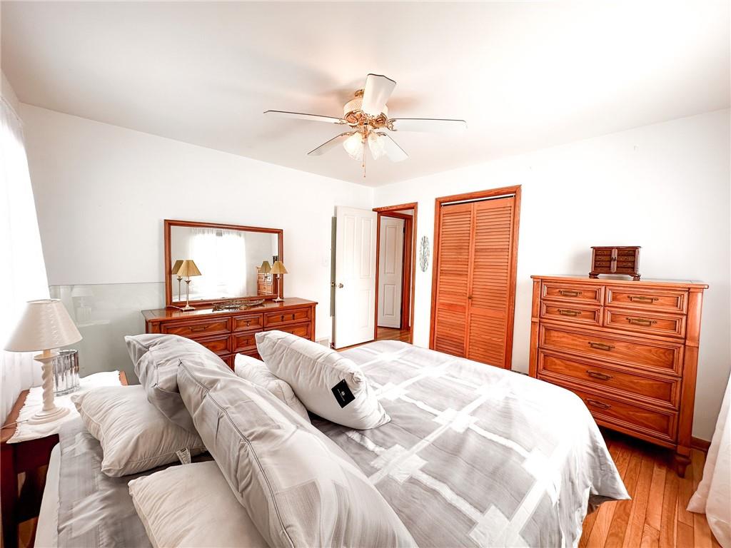 112 Reed Drive Industry, PA 15052 - Photo 13 of 38 a bedroom with a bed and wooden floor