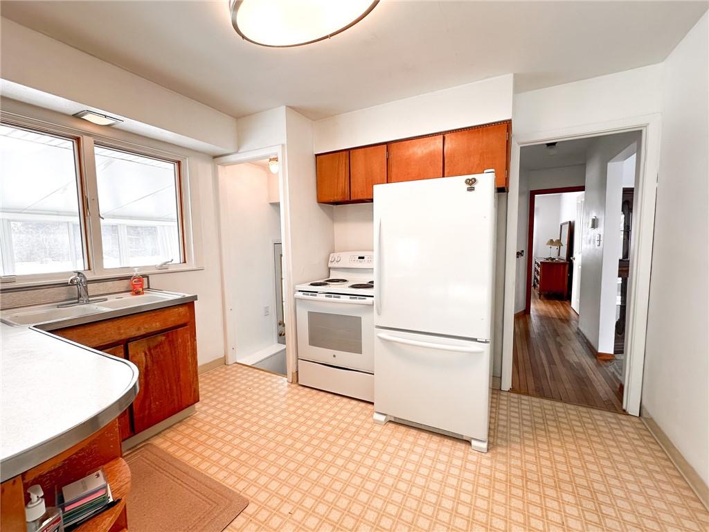 112 Reed Drive Industry, PA 15052 - Photo 15 of 38 a kitchen with stainless steel appliances granite countertop a refrigerator a stove and a sink with large window