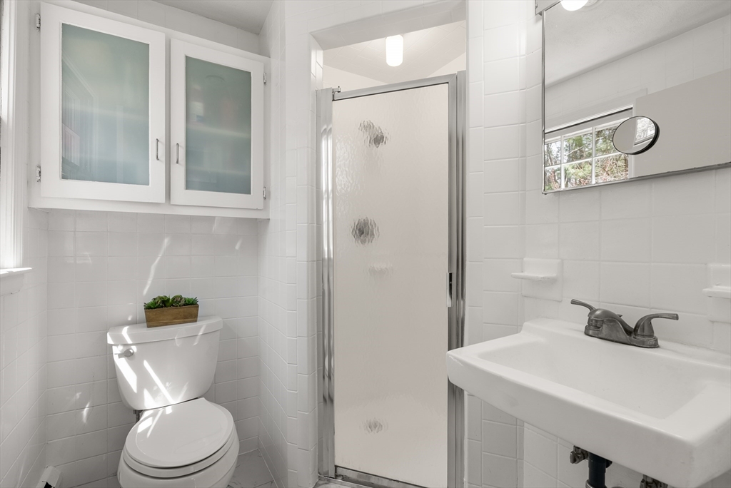 39 Dakin Road Sudbury, MA 01776 - Photo 15 of 34 a bathroom with a toilet a sink and shower