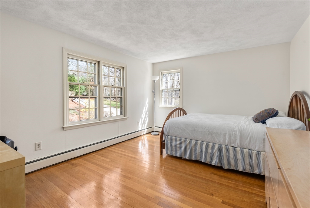 39 Dakin Road Sudbury, MA 01776 - Photo 16 of 34 a bedroom with a bed and a large window