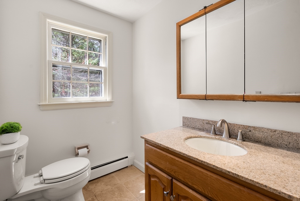 39 Dakin Road Sudbury, MA 01776 - Photo 20 of 34 a bathroom with a granite countertop sink and a toilet