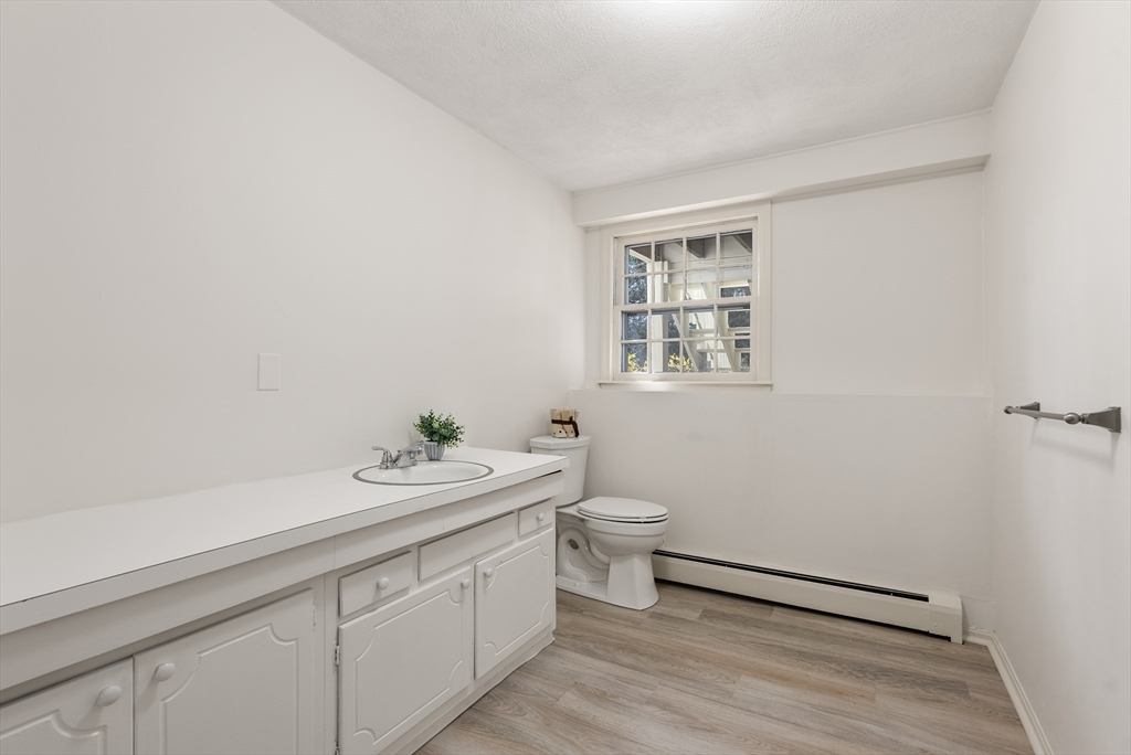 39 Dakin Road Sudbury, MA 01776 - Photo 25 of 34 a bathroom with a sink a toilet and a window