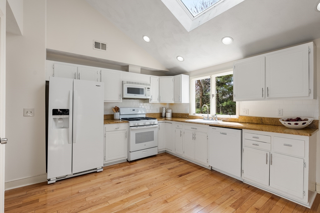 39 Dakin Road Sudbury, MA 01776 - Photo 9 of 34 a kitchen with granite countertop white cabinets and white appliances