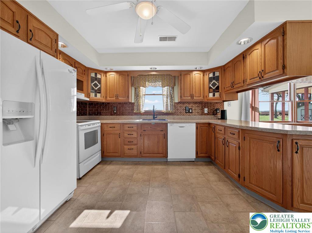 7098 Limerick Square Bath, PA 18014 - Photo 8 of 31 a kitchen with stainless steel appliances granite countertop a stove sink and cabinets