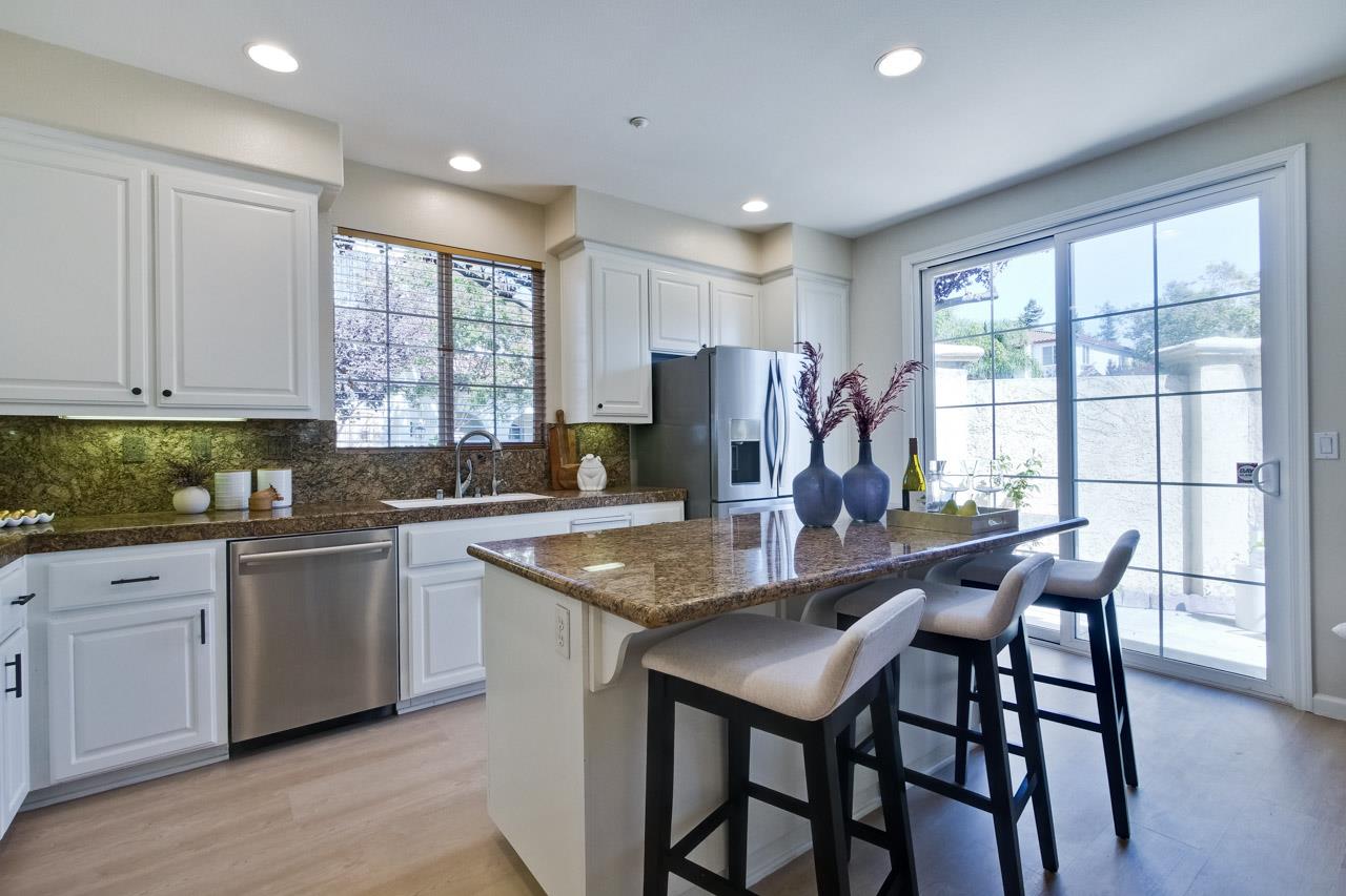 35489 Monterra Circle Union City, CA 94587 - Photo 14 of 52 a kitchen with stainless steel appliances granite countertop dining table chairs and wooden floor