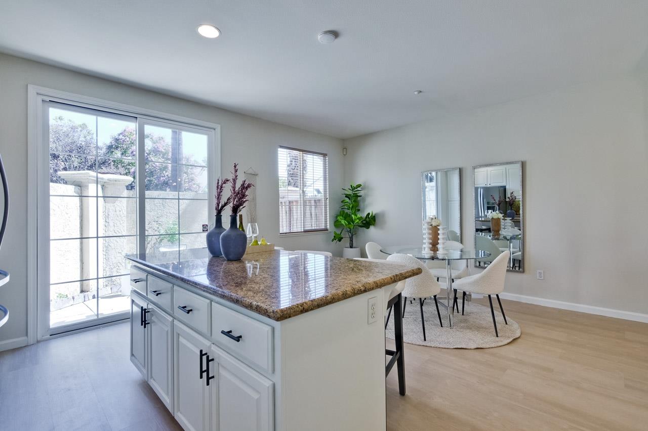 35489 Monterra Circle Union City, CA 94587 - Photo 18 of 52 a dining room with kitchen island granite countertop furniture a large window and a wooden floor