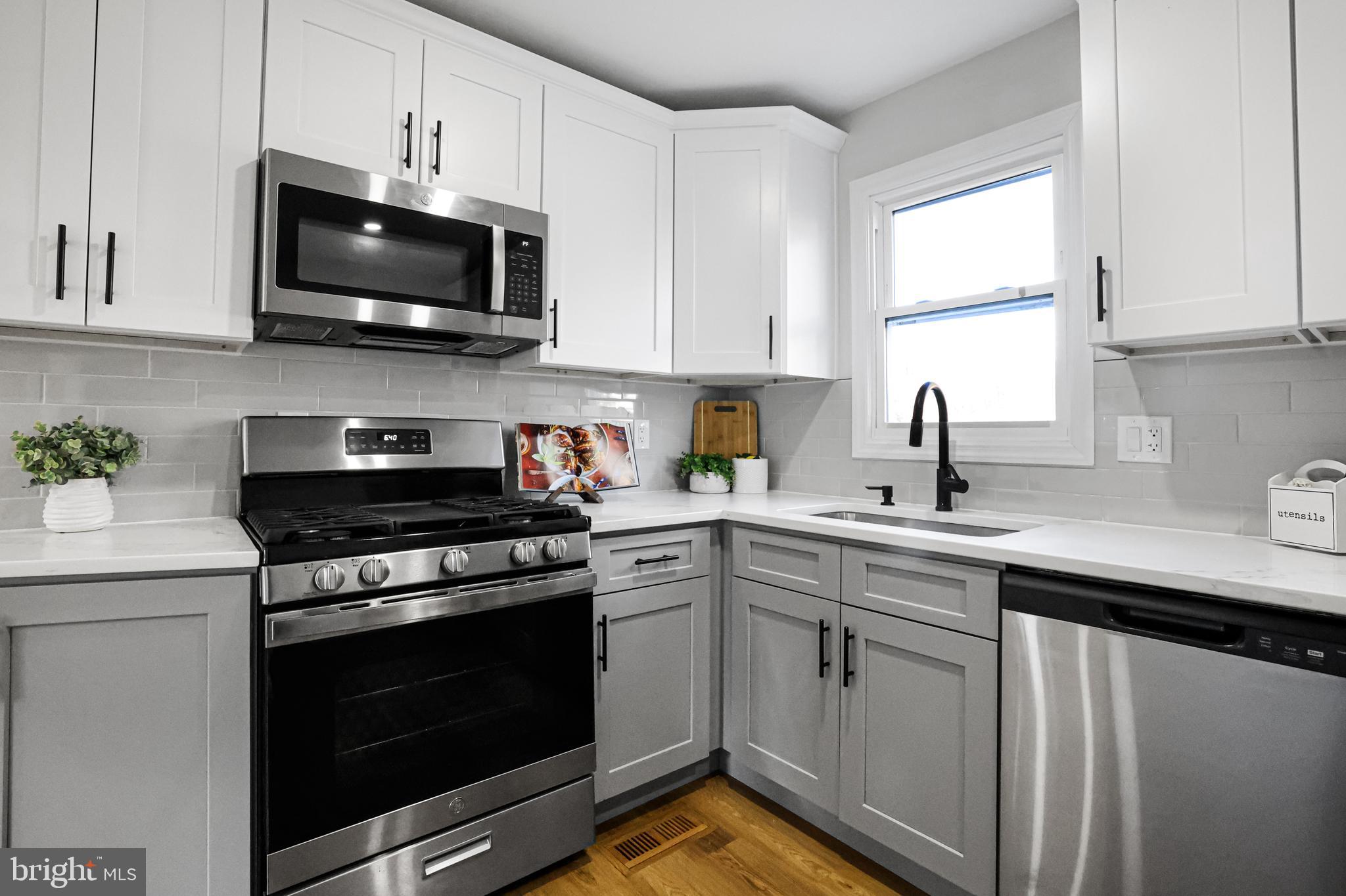 4305 Garrett Park Road Silver Spring, MD 20906 - Photo 12 of 39 a kitchen with white cabinets and appliances