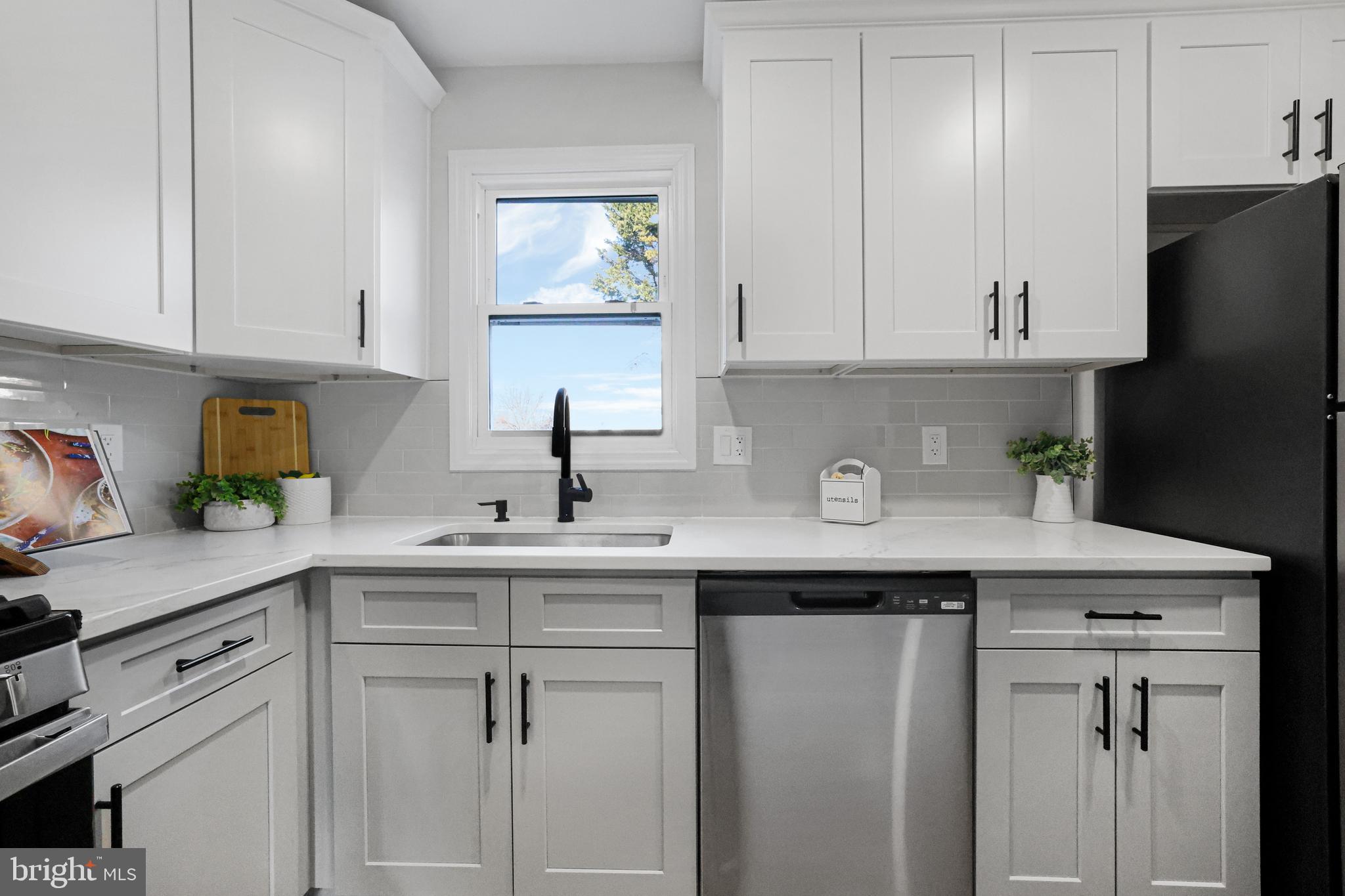 4305 Garrett Park Road Silver Spring, MD 20906 - Photo 13 of 39 a kitchen with stainless steel appliances granite countertop a sink a refrigerator and cabinets