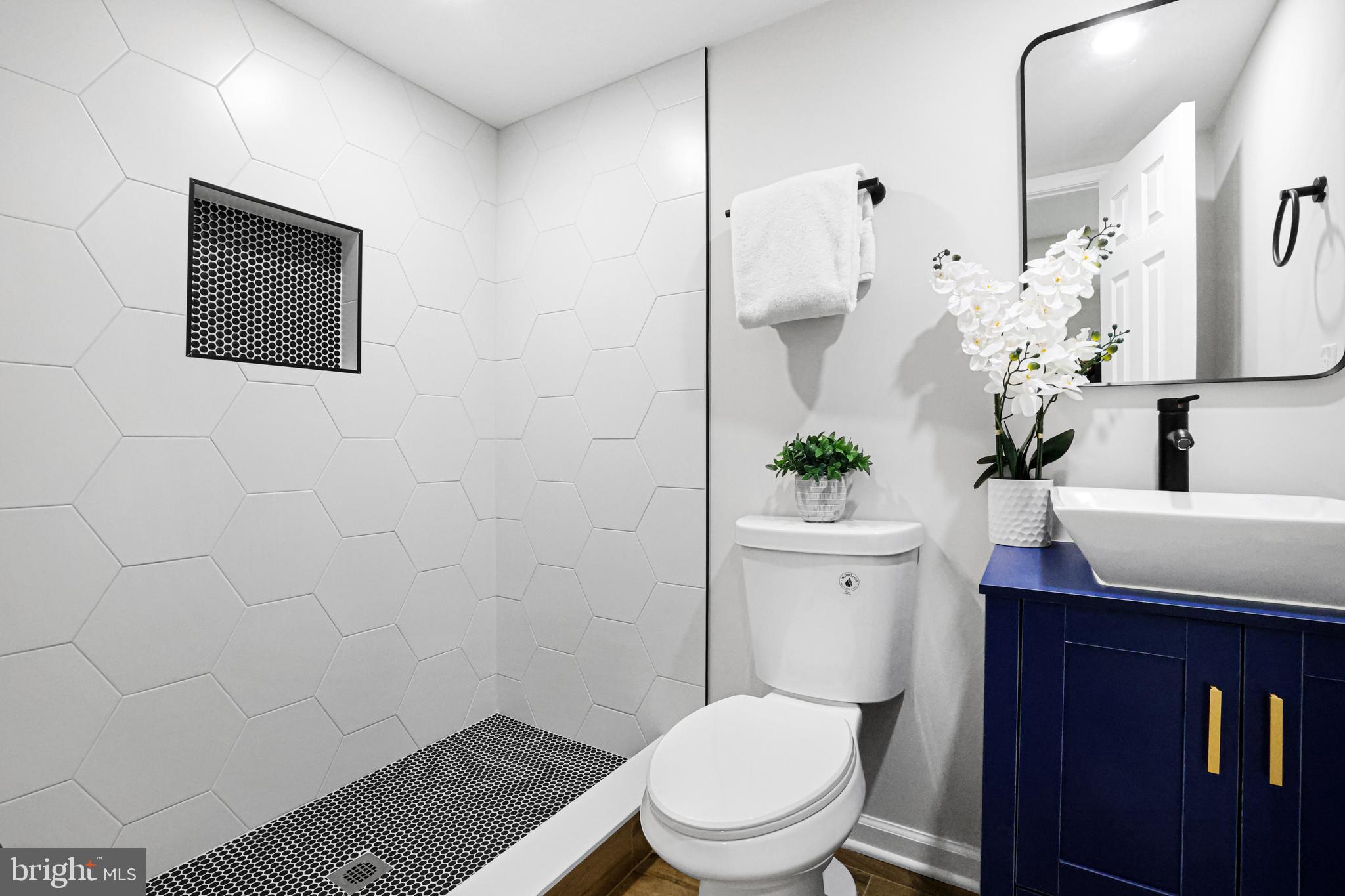 4305 Garrett Park Road Silver Spring, MD 20906 - Photo 33 of 39 a bathroom with a toilet a sink and mirror