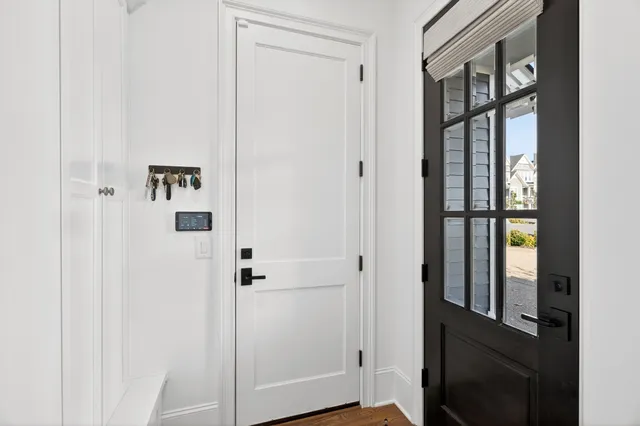 a bedroom with a bed couch and a large window