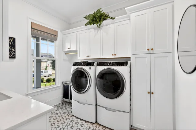 a bedroom with a bed window and a flat screen tv