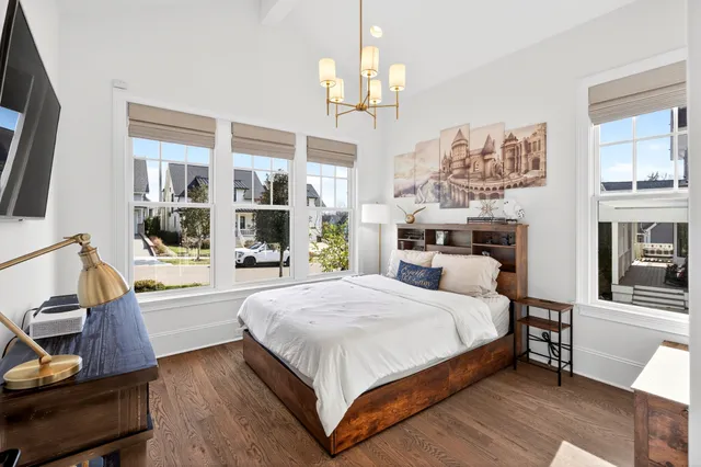 a bedroom with a bed and a chandelier