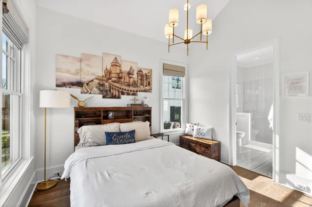 a bathroom with a bathtub a sink and a large mirror