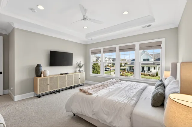 a bedroom with a bed and a chandelier