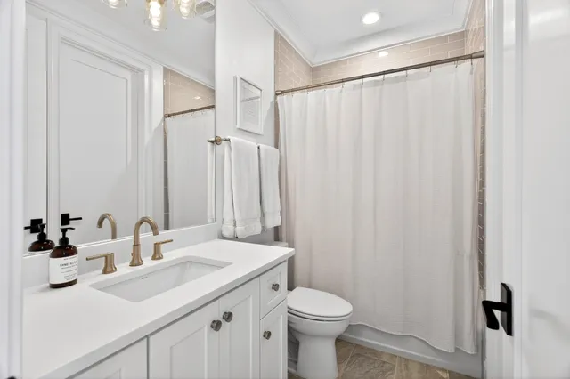 an aerial view of a house with large trees and a big yard