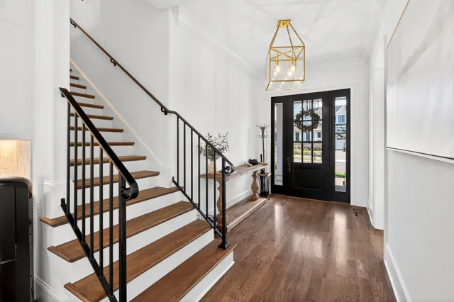 a living room with stainless steel appliances furniture a fireplace and a flat screen tv