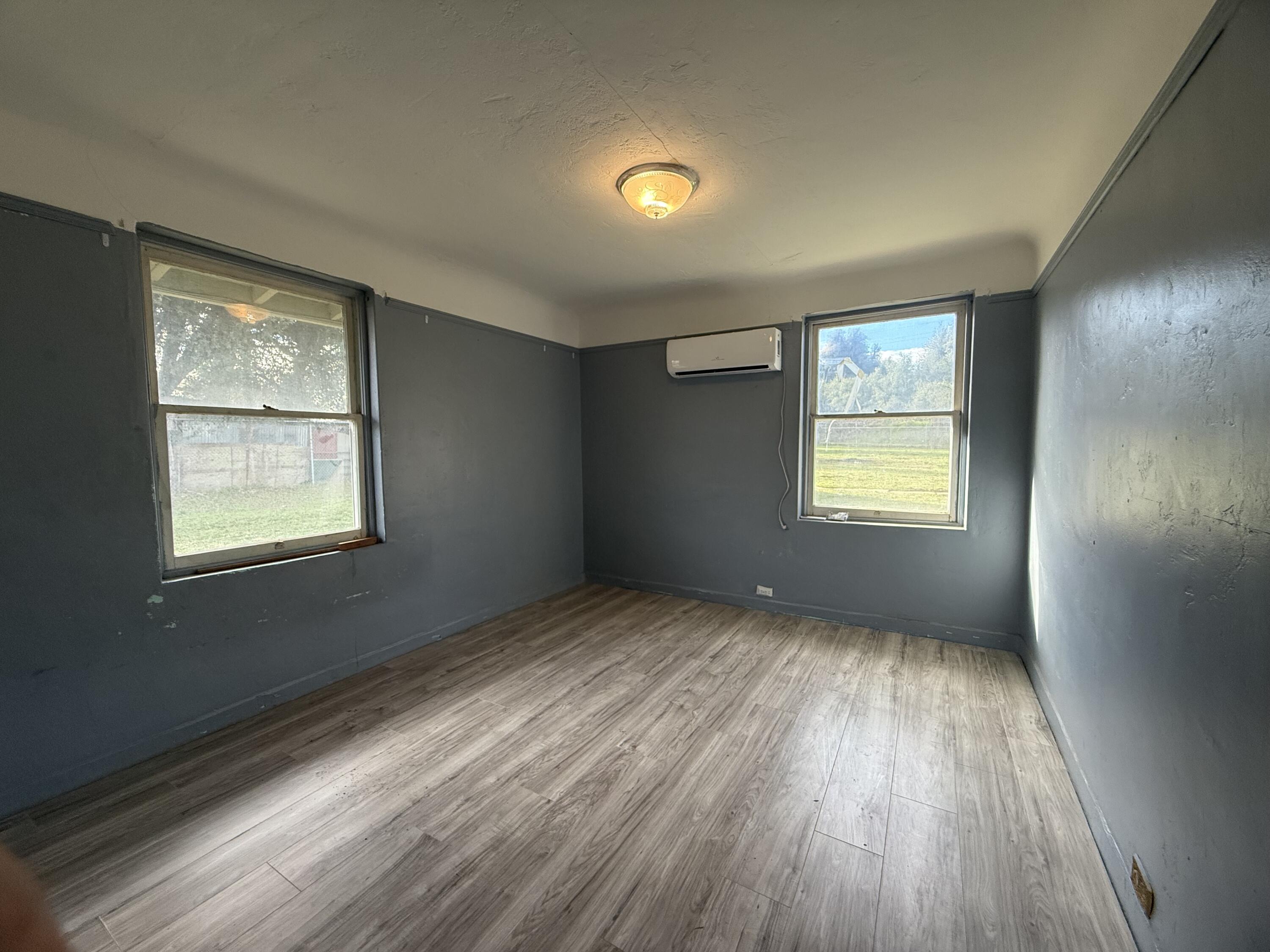 6820 Highway 273 Anderson, CA 96007 - Photo 9 of 35 a view of an empty room with wooden floor and a window