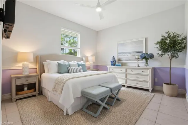 a view of an empty room with a window and a kitchen