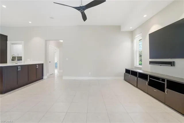 a view of kitchen with sink microwave and cabinets