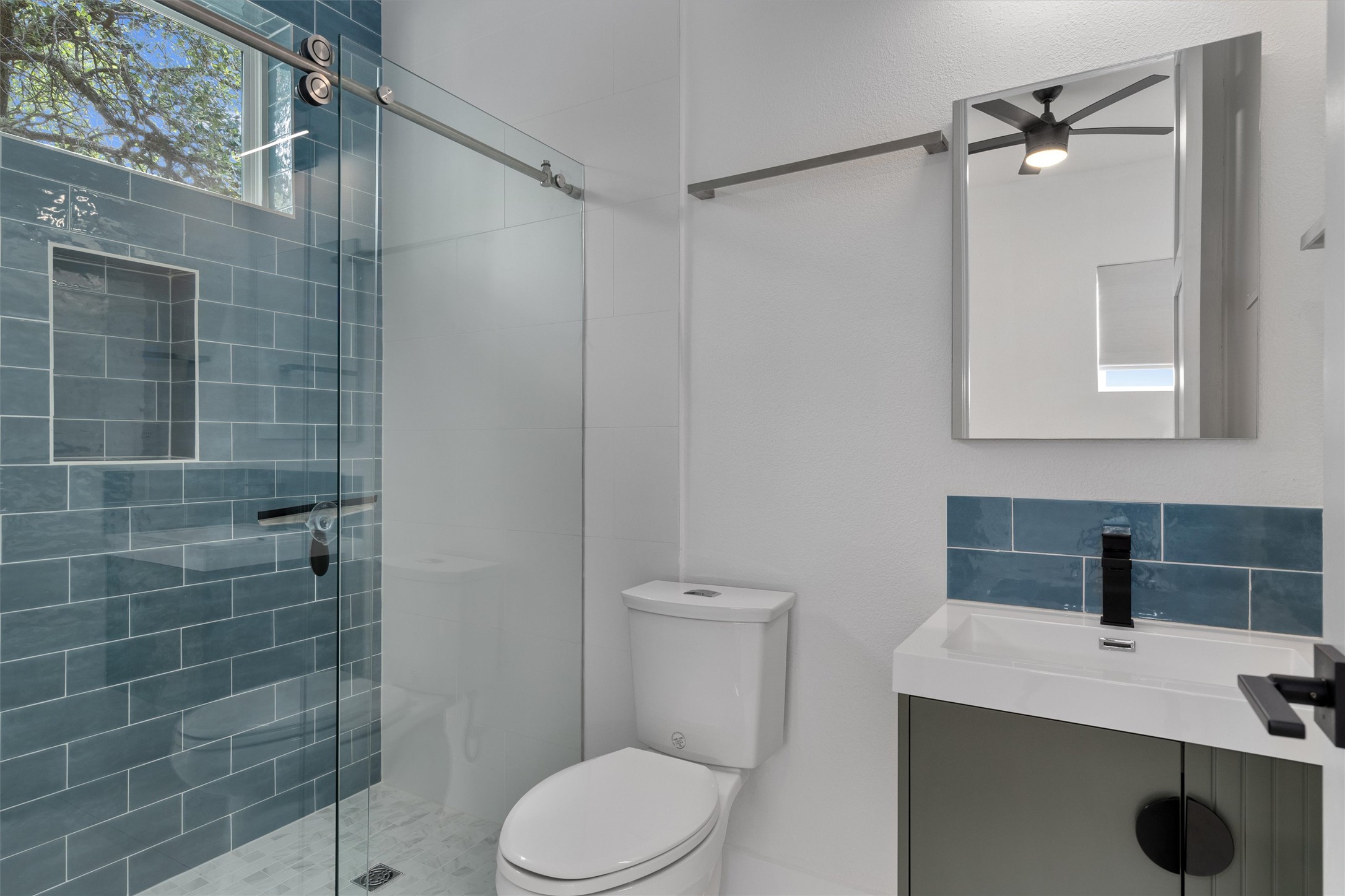 4712 Reyes Street, Unit 1 Austin, TX 78721 - Photo 18 of 38 a bathroom with a sink a toilet and shower
