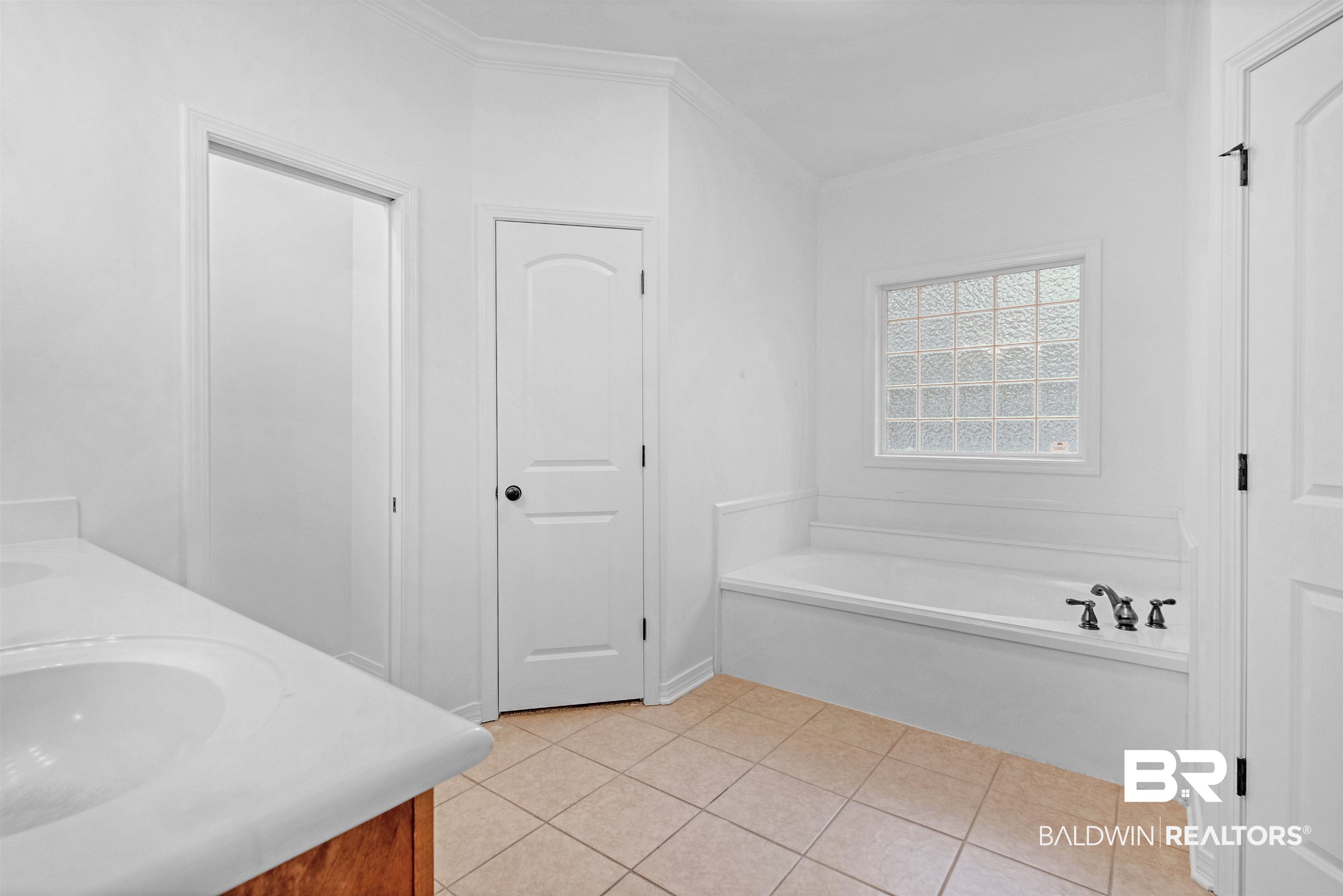 1007 Linlen Avenue Mobile, AL 36609 - Photo 16 of 21 Bathroom with a tub to relax in, vanity, tile patterned floors, and crown molding